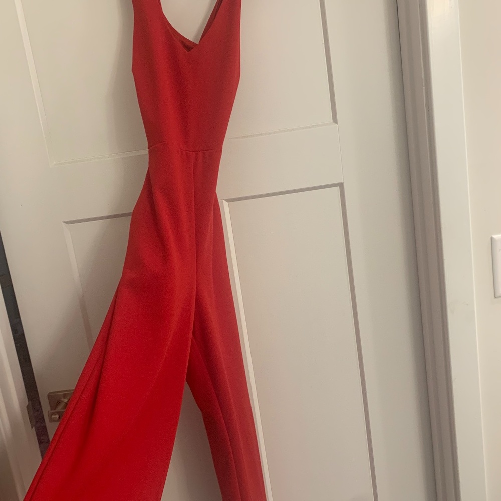 Red jumpsuit low cross-back with pockets